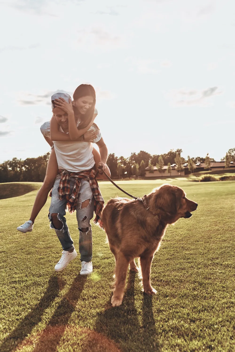 Couple outdoors with their dog